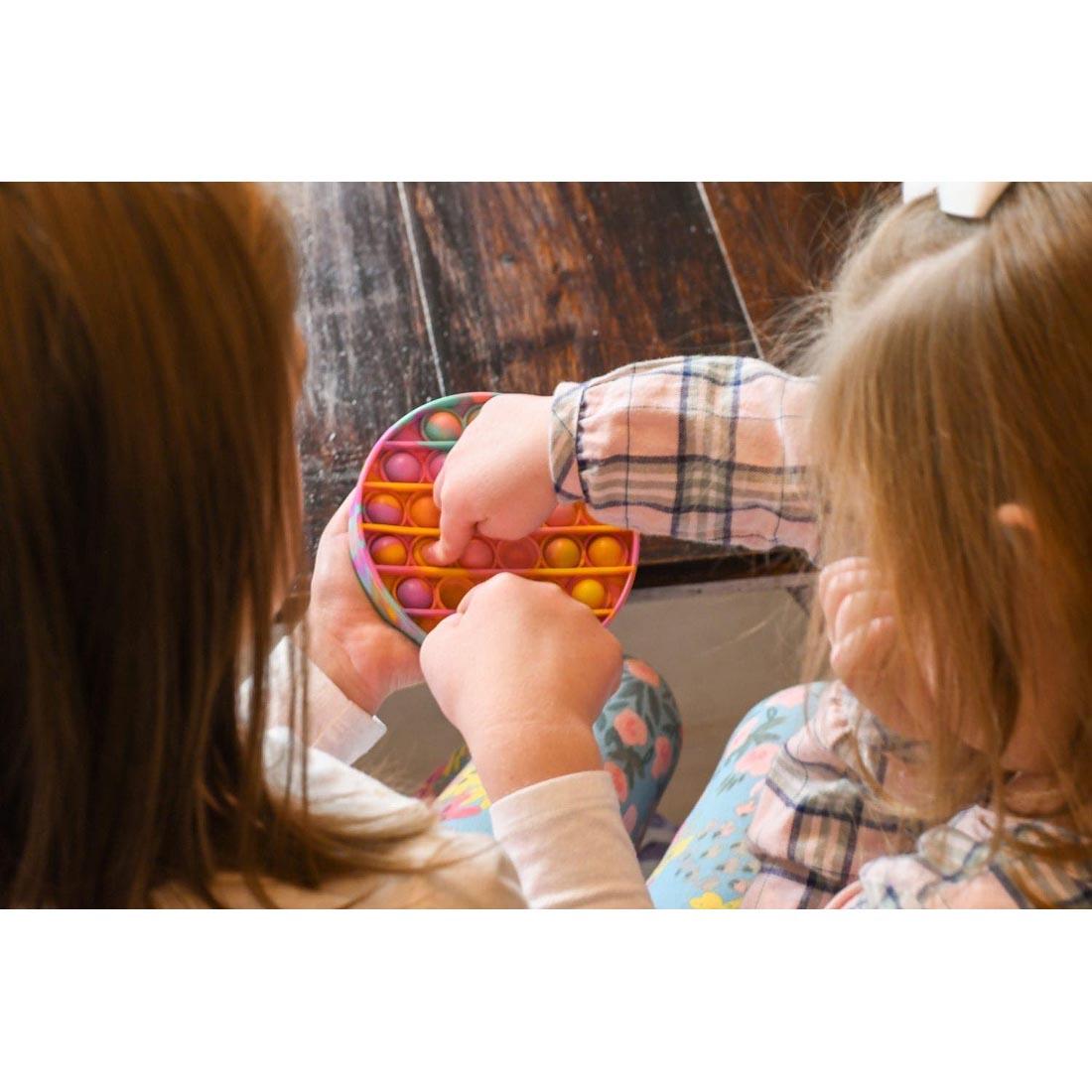 two children playing with the Go PoP! Roundo Tie-Dye