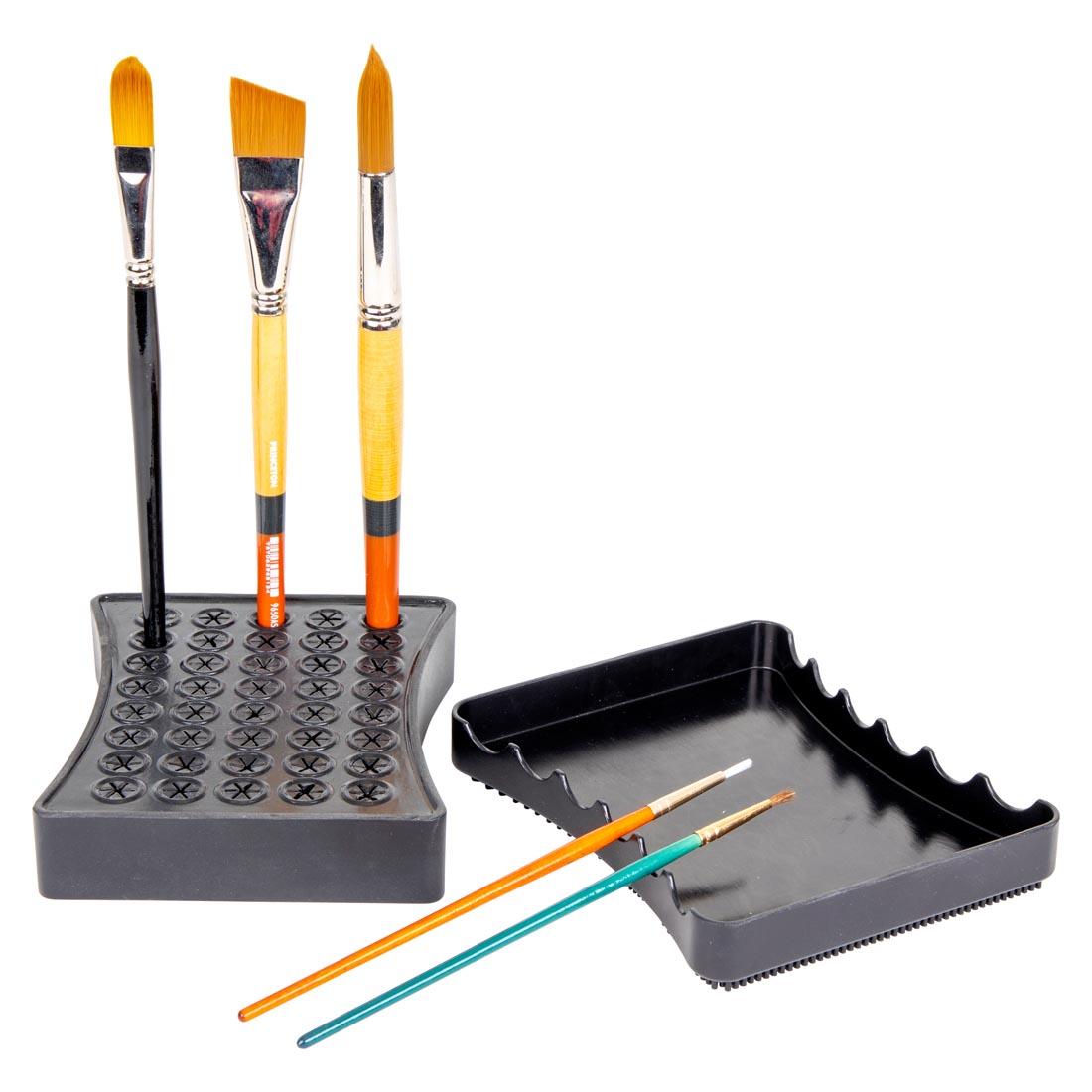 ArtBin Brush Drying Rack holding three brushes vertically and two brushes horizontally