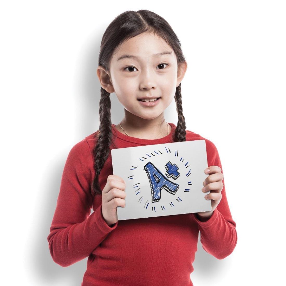 Girl holding Flipside 5x7" white Dry Erase Board, with A+ written on the board