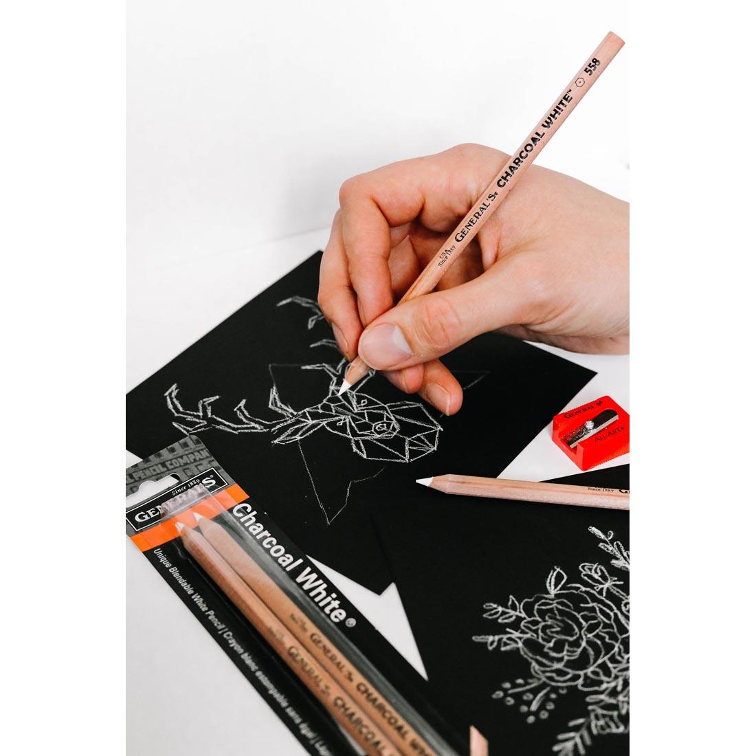 Hand drawing an animal on black paper with a General's Charcoal White Pencil
