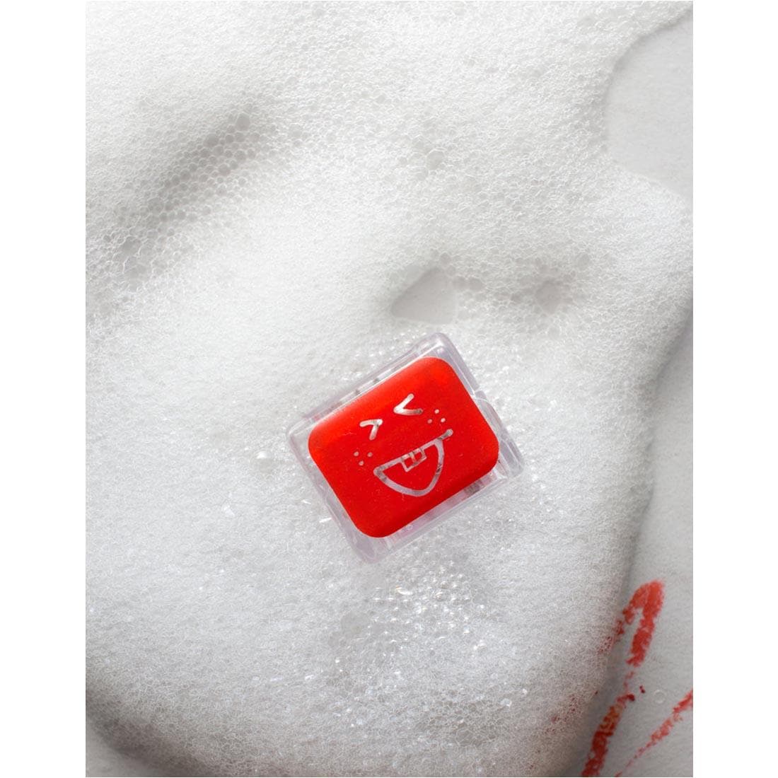 Sammy Red Glo Pals Water-Activated Light Up Cube floating in a bubble bath