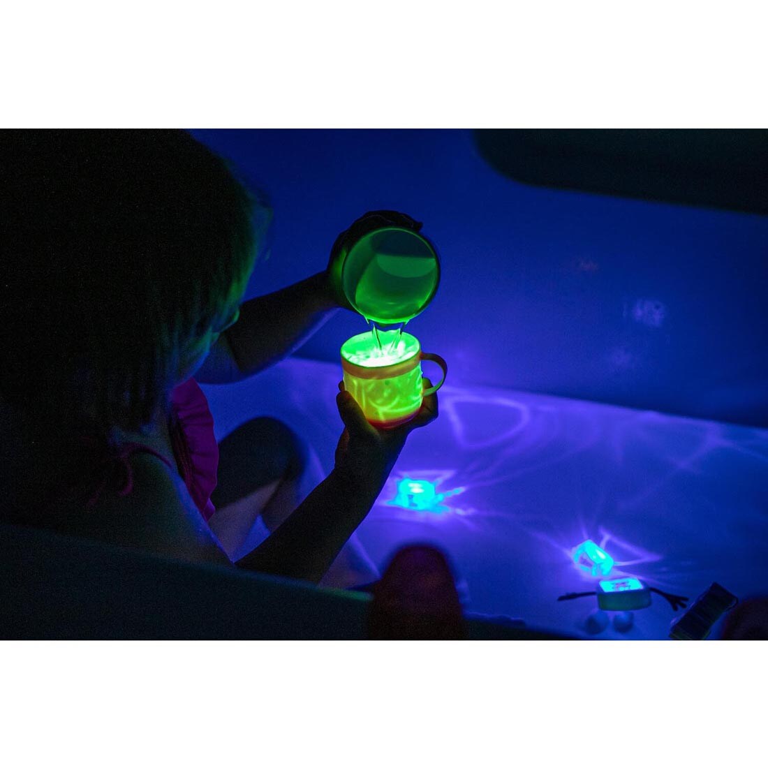 child in tub playing with Glo Pals Water-Activated Light Up Cubes