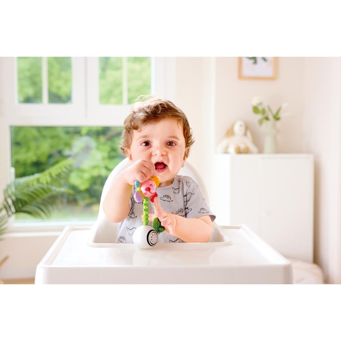 child playing with the Shake 'N Sparkle Flower Rattle