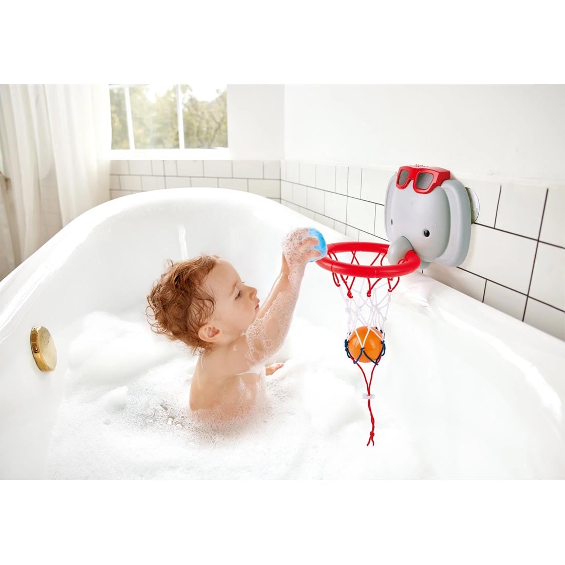 Child in a bubble bath playing with the Bath Basketball Elephant Pal By Hape