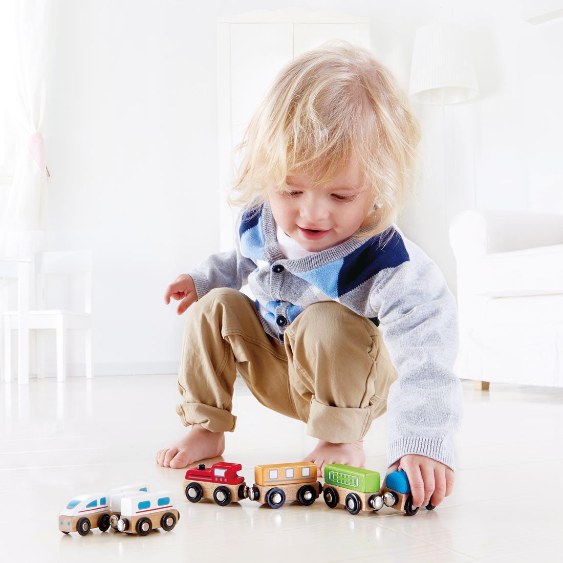 child playing with the Classic Magnetic Train Set By Hape