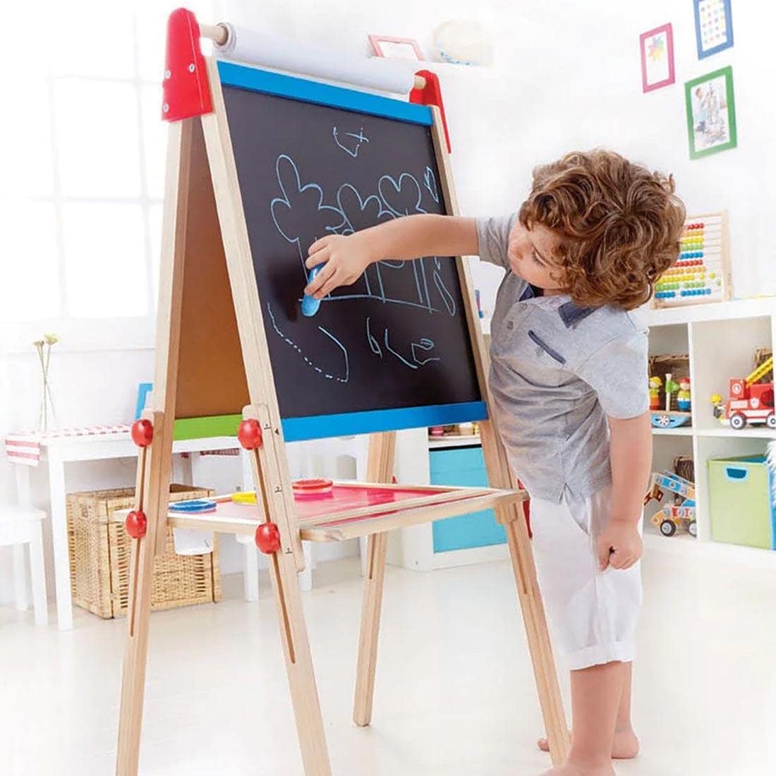 Child making a chalk drawing on the All-In-One Wooden Kid's Art Easel By Hape