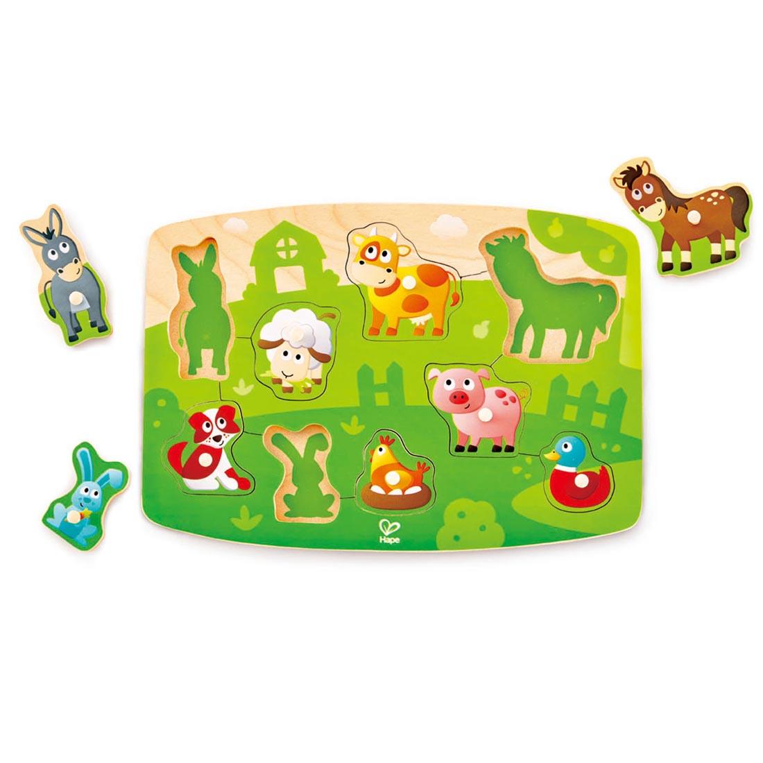 9-Piece Farmyard Peg Puzzle By Hape with three of the pieces off to the side