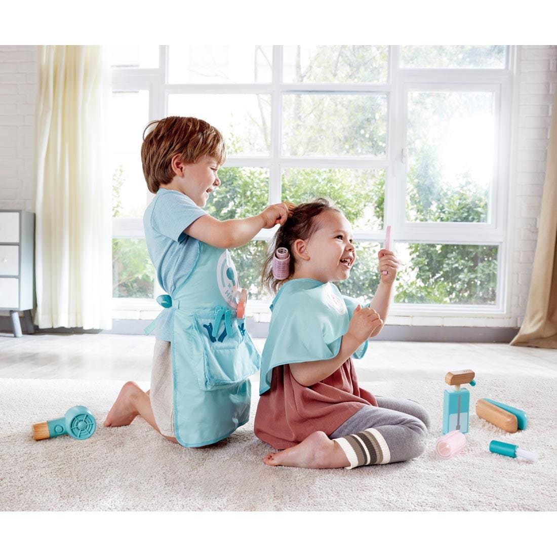 two children playing with the Super Stylish Hair Salon Set By Hape