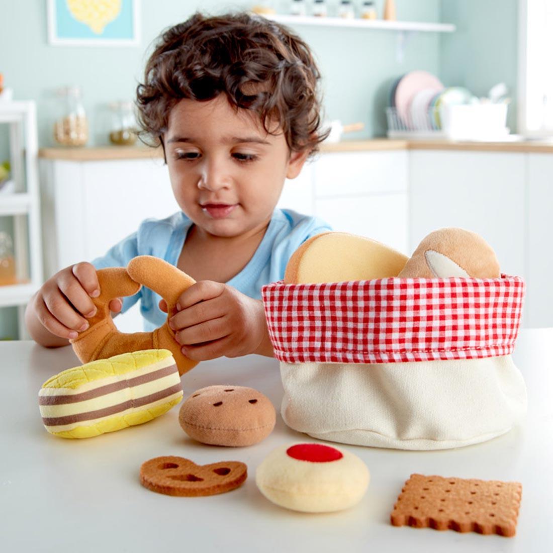 Child playing with the Toddler Bread Basket By Hape