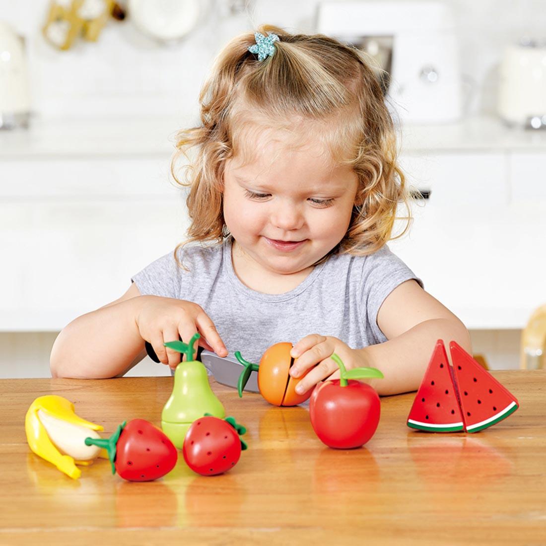 Child playing with the Healthy Fruit Play Set By Hape