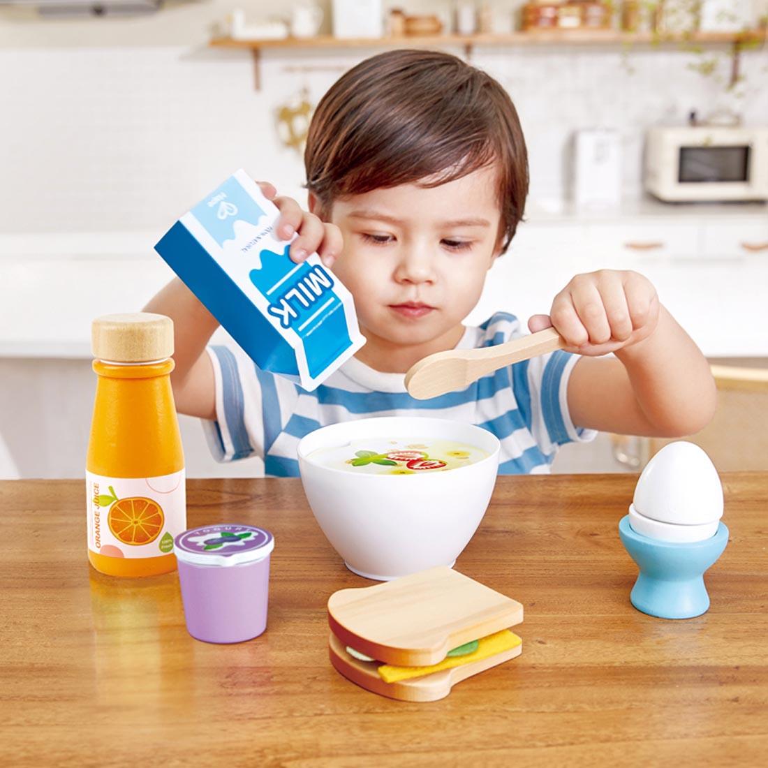 Child playing with the Delicious Wooden Breakfast Playset By Hape