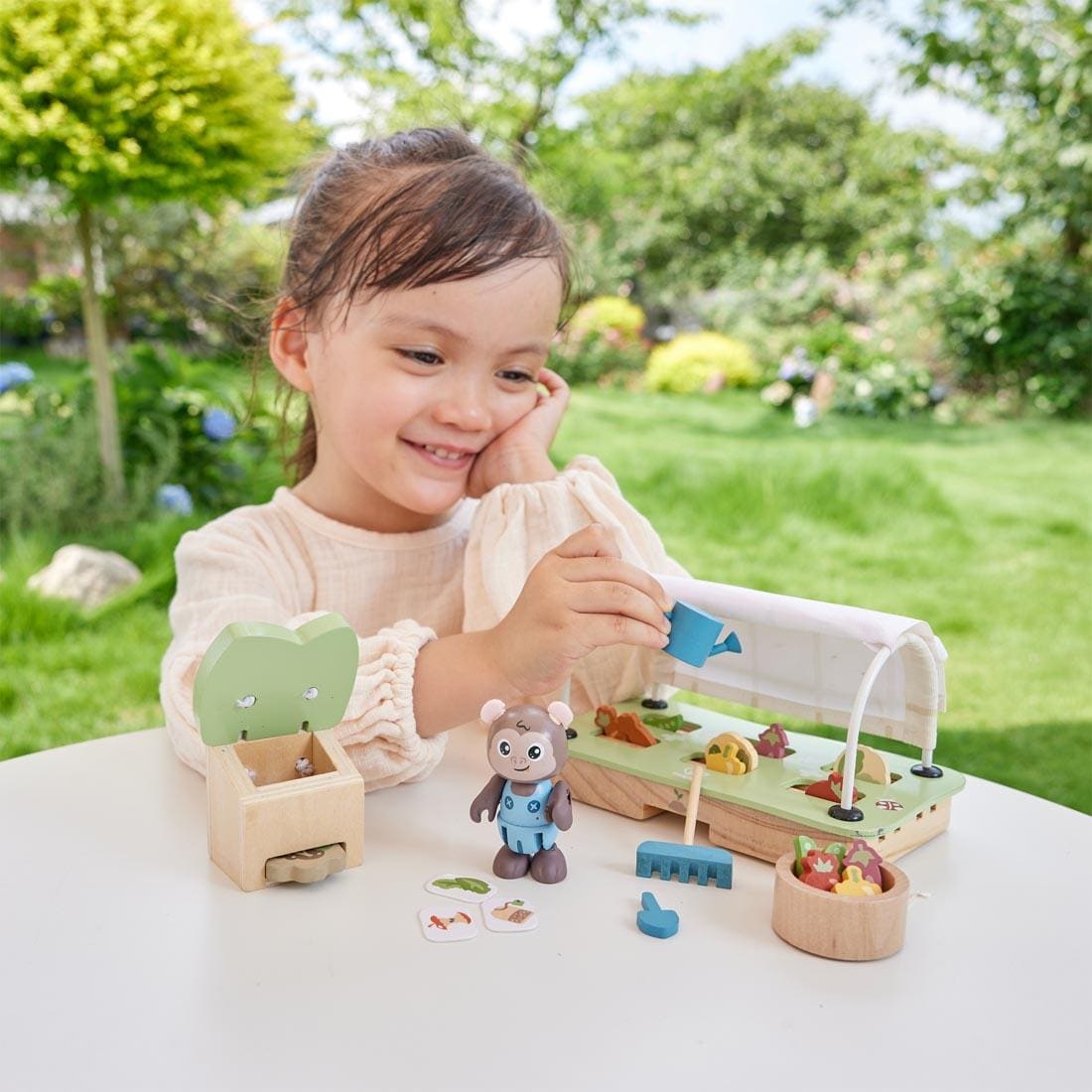 child playing with the Organic Greenhouse Playset By Hape