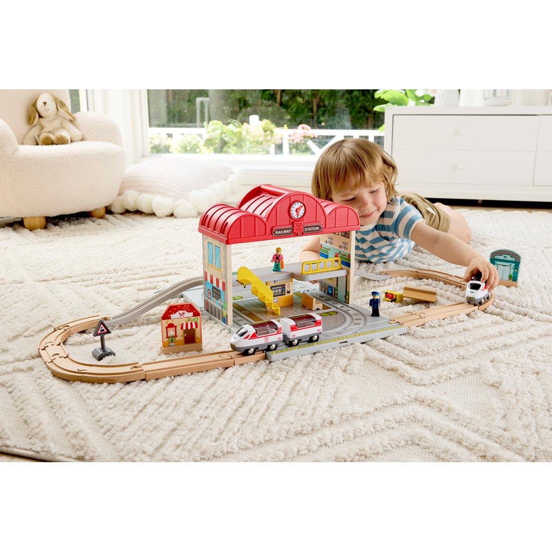 child playing with the Portable Train Station Set