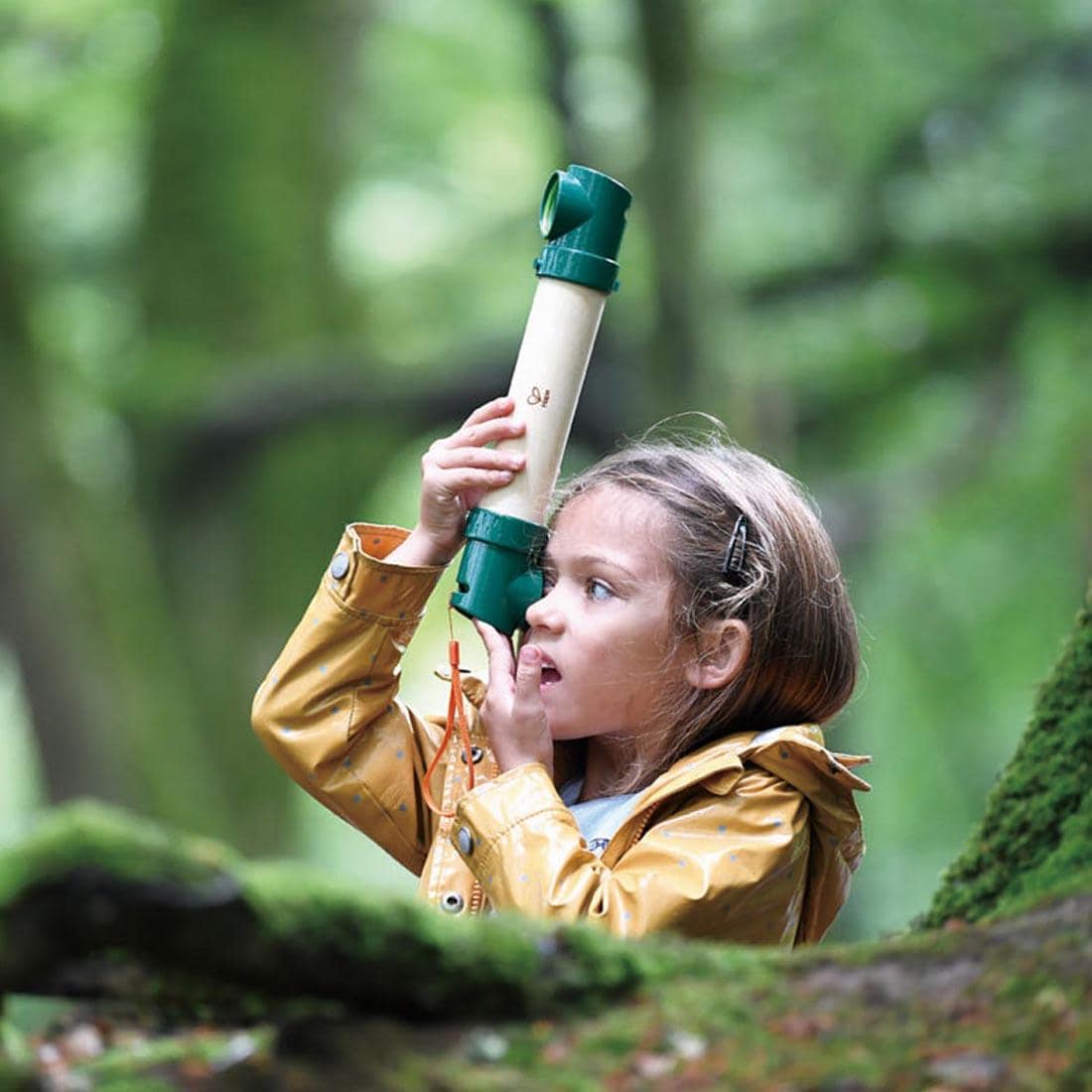 Child outdoors looking through the Hide-And-Seek Periscope By Hape