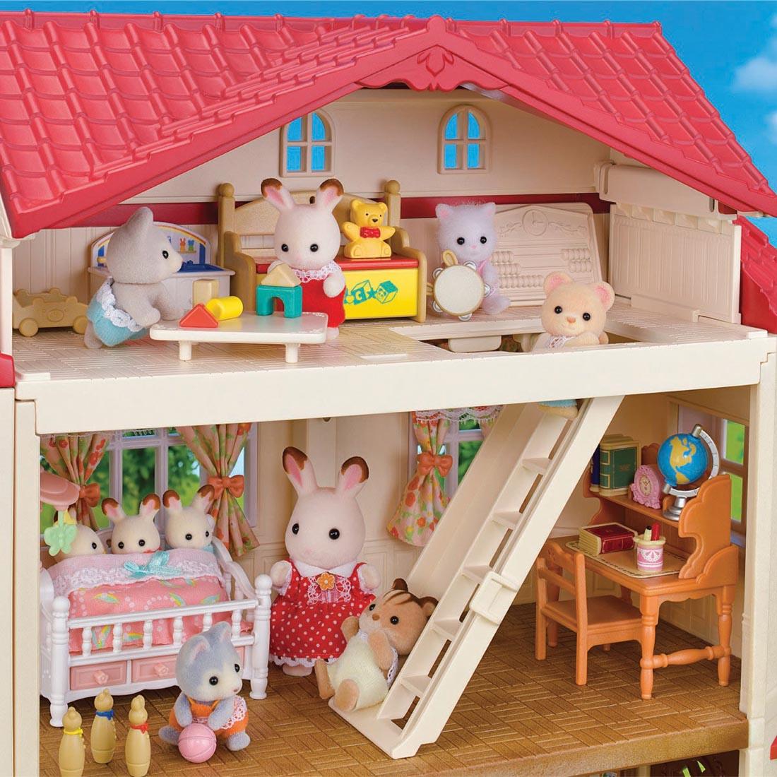 lots of critters shown inside the Calico Critters Red Roof Country Home With Secret Attic Playroom