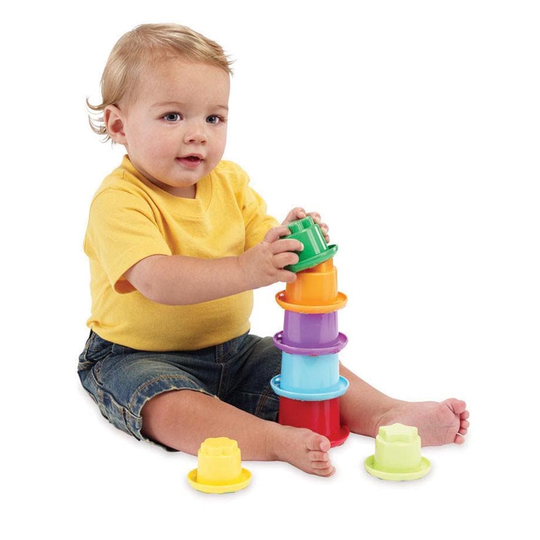 Child sitting and playing with the Stack n' Nest Cups by Early Years