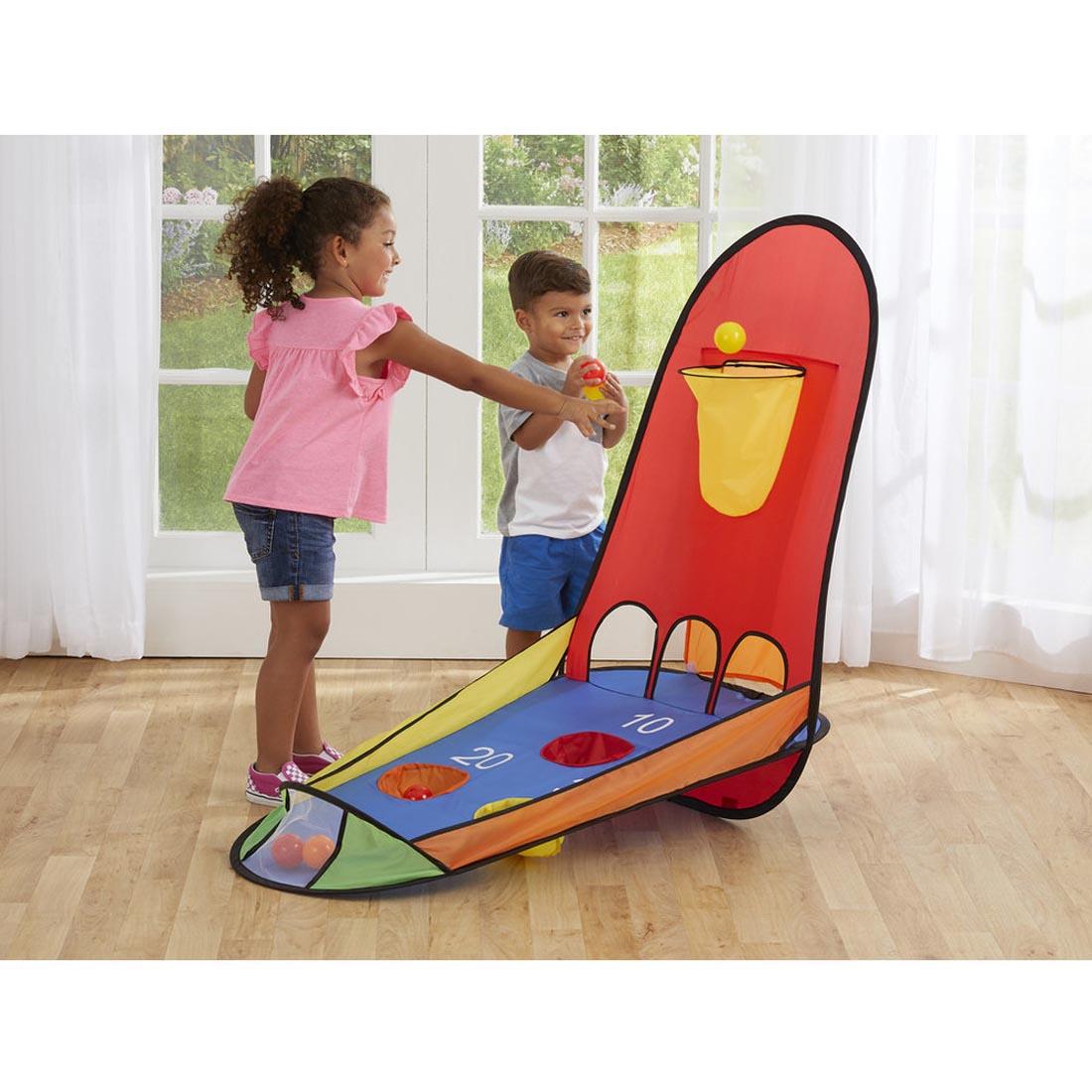 Two children playing with the Kidoozie Pop-Up Basketball Set