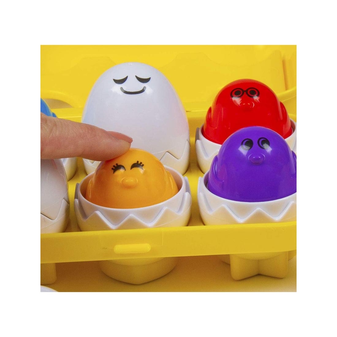 finger pushing down one of the eggs in Peek 'N Peep Eggs By Kidoozie