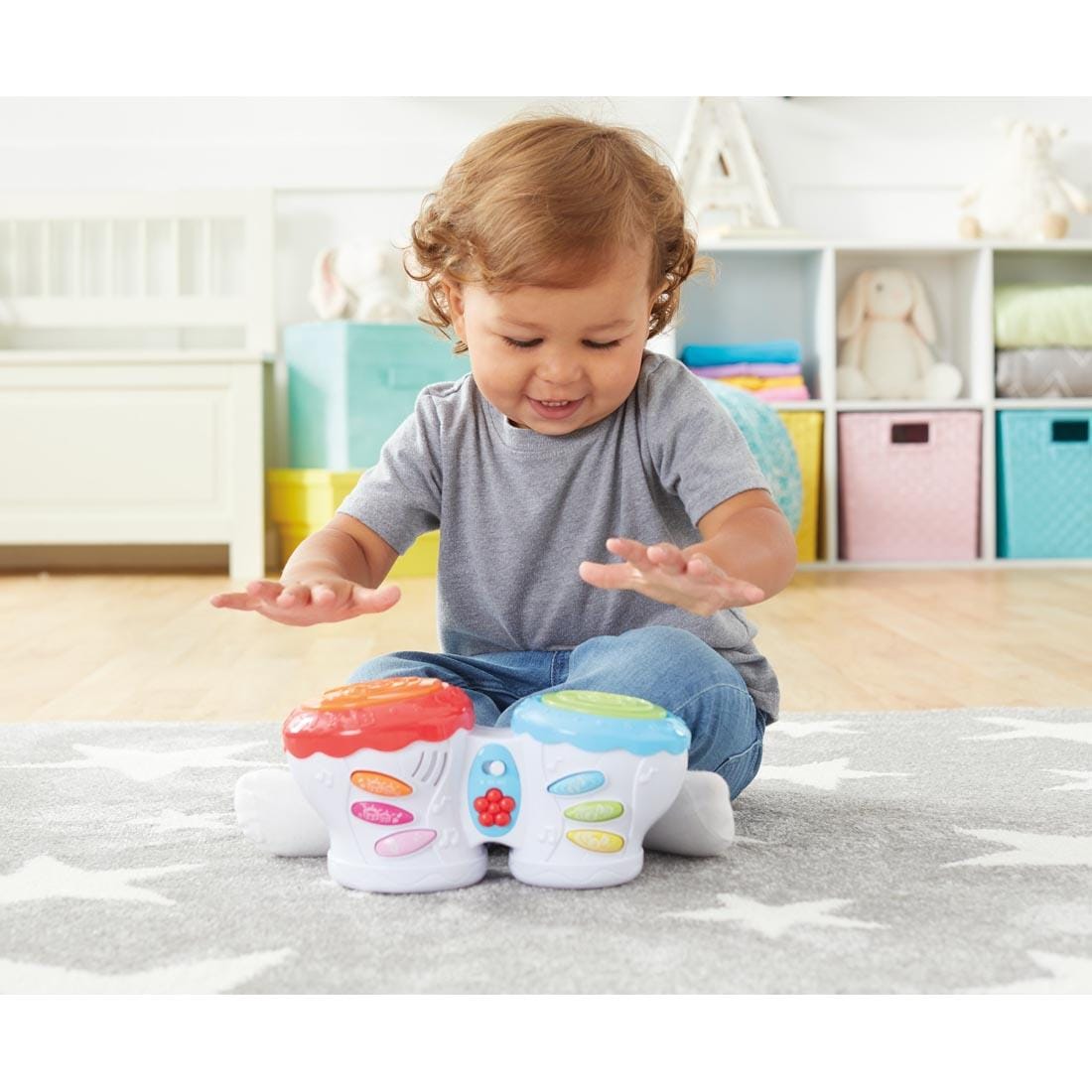 Child playing the Kidoozie Flash Beat Drums