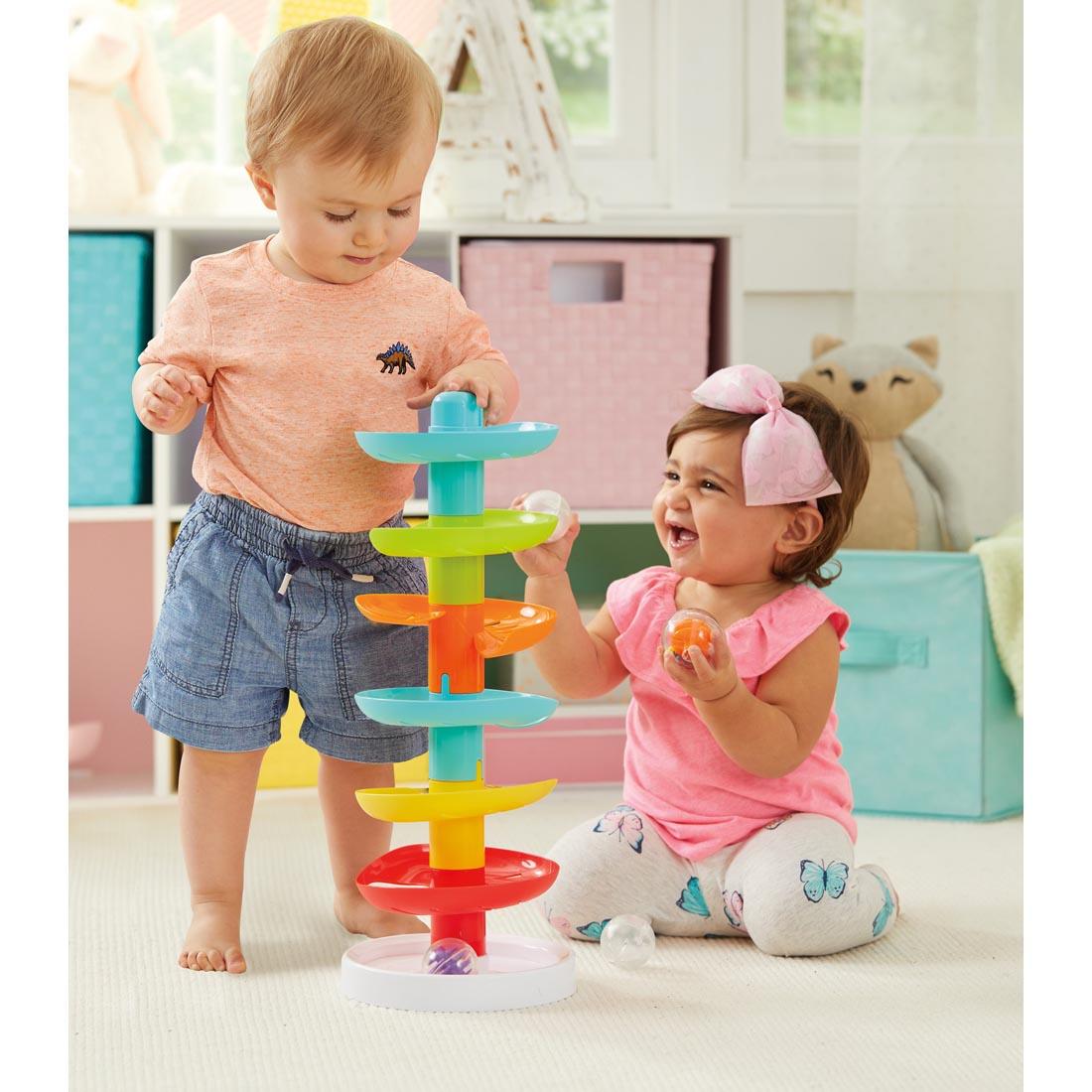 Two toddlers playing with the Kidoozie Whirl 'n Go Ball Tower