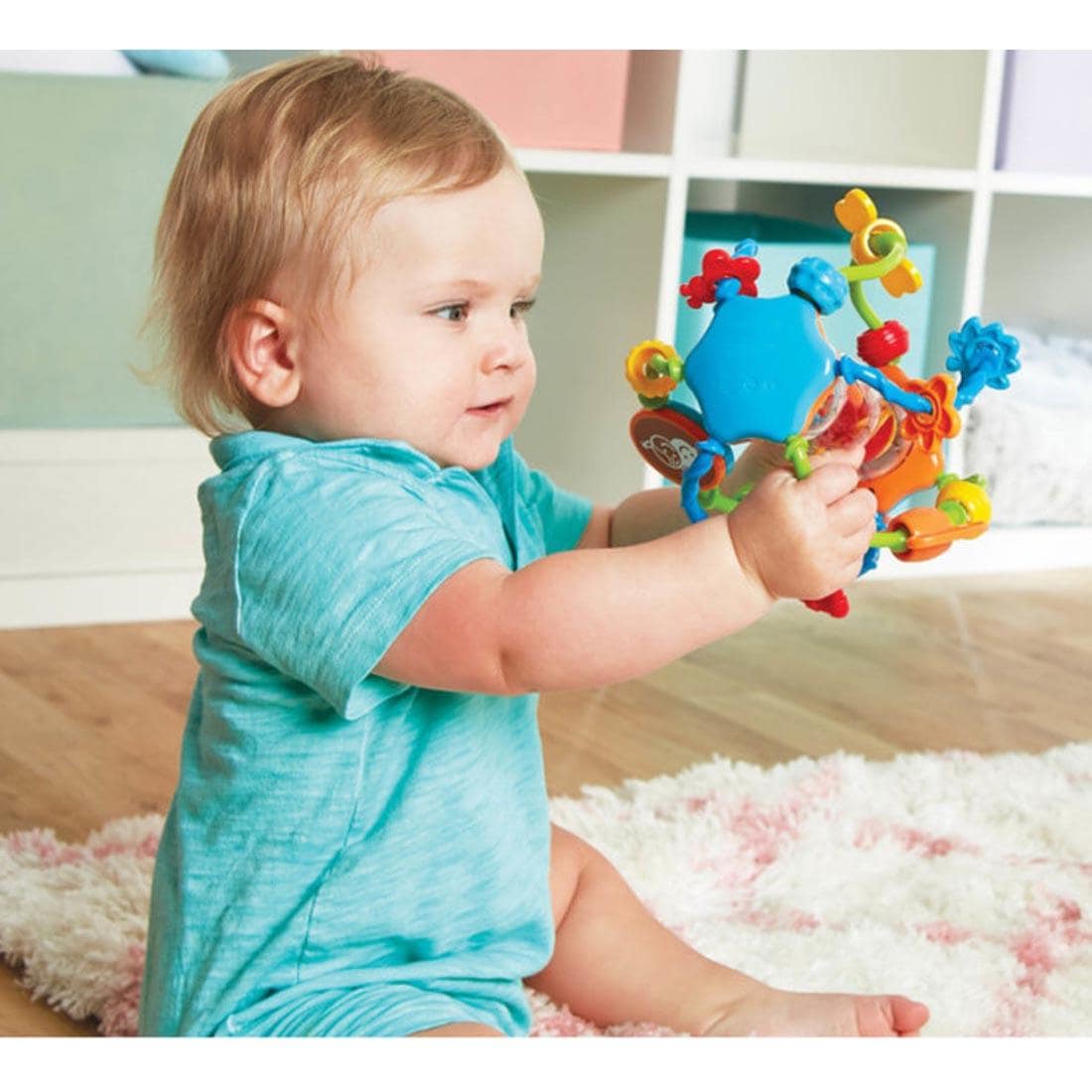 child playing with the Little Hands Activity Ball By Kidoozie