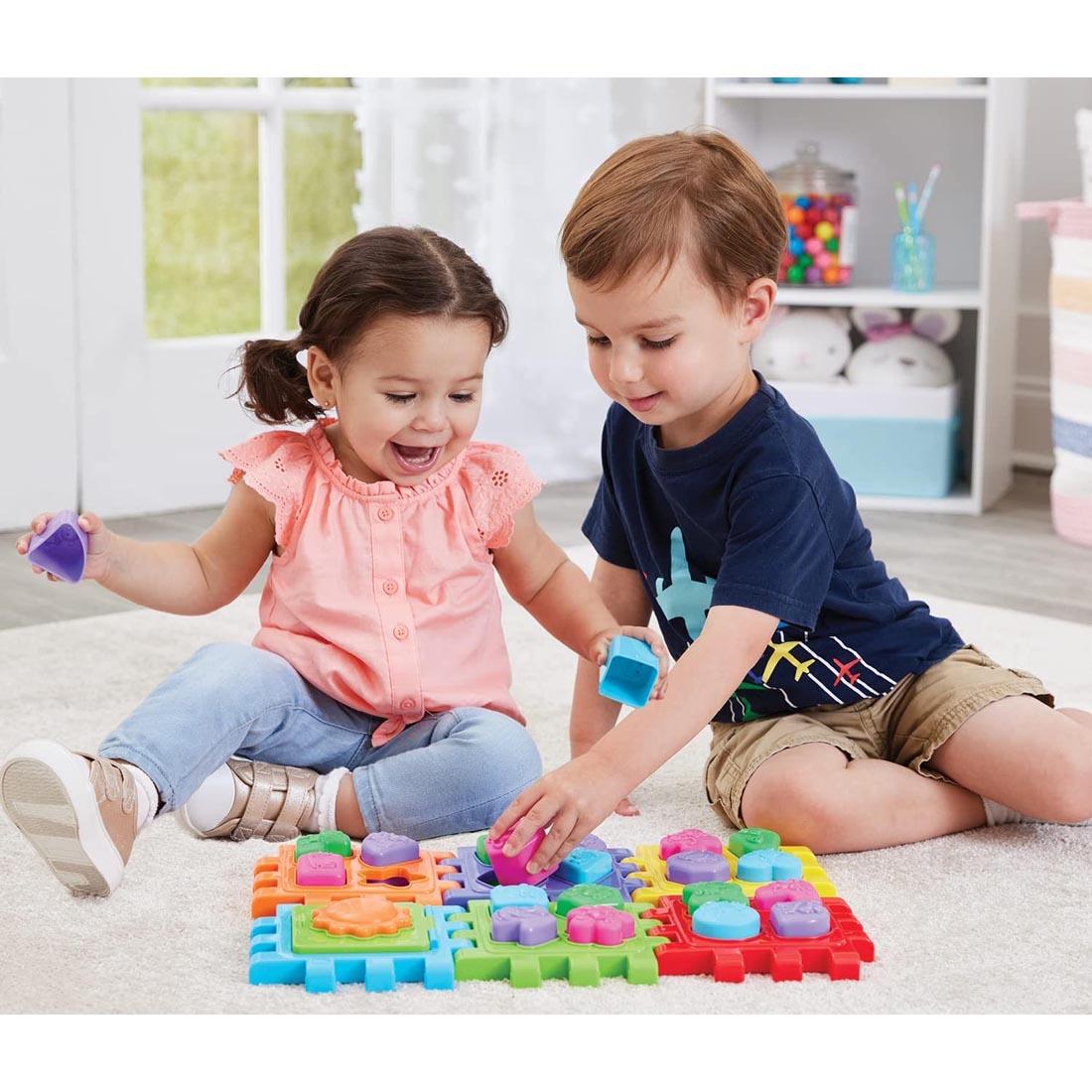 Two children playing with the 2-In-1 Shape Sorter By Kidoozie