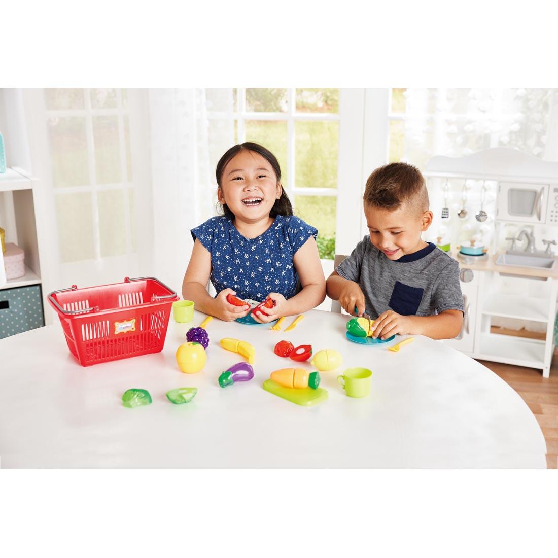 two children playing with the Slice 'N Play Shopping Set By Kidoozie