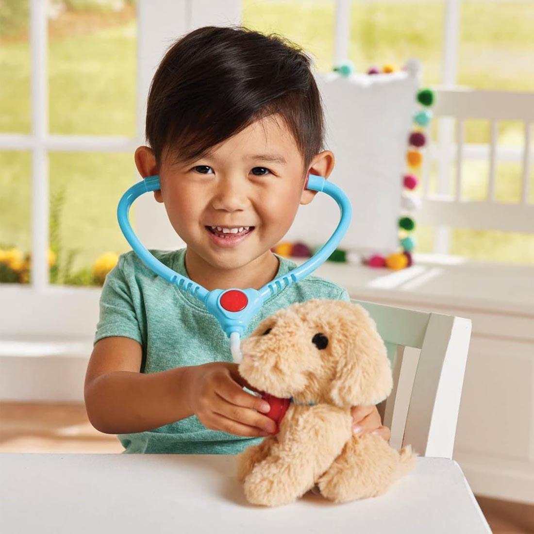 child playing with the dog and stethoscope from the Groom 'N Care Pet Carrier By Kidoozie