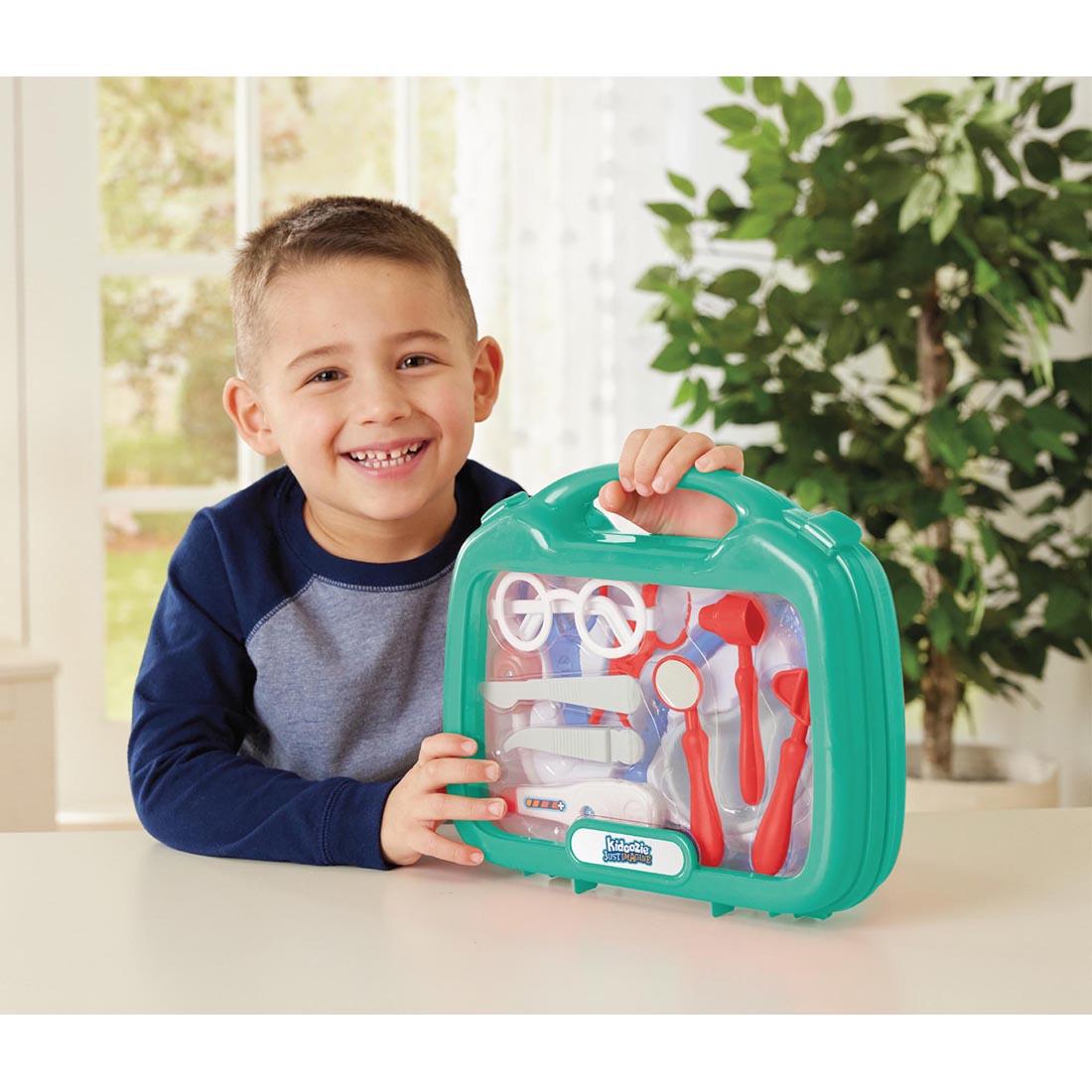child holding the My First Doctor's Kit By Kidoozie