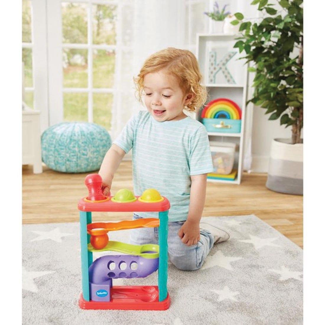 child on their knees playing with the Pound-A-Ball Tower By Kidoozie