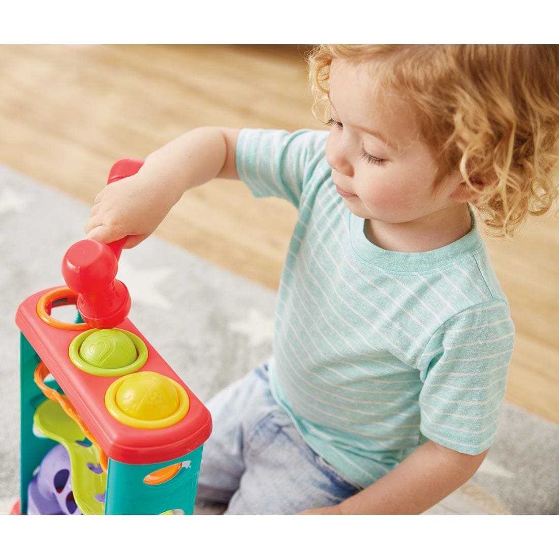 child hitting a ball on the Pound-A-Ball Tower By Kidoozie, shown from above