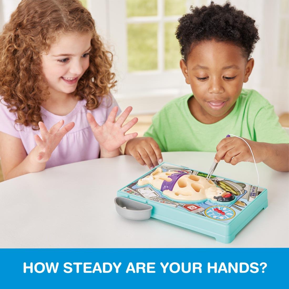 Two children playing Doctor's Dilemma game, with the words: How steady are your hands?