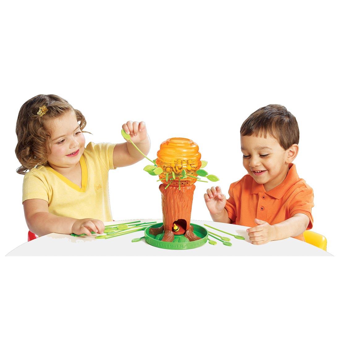 Two children playing the Honey Bee Tree Game by International Playthings
