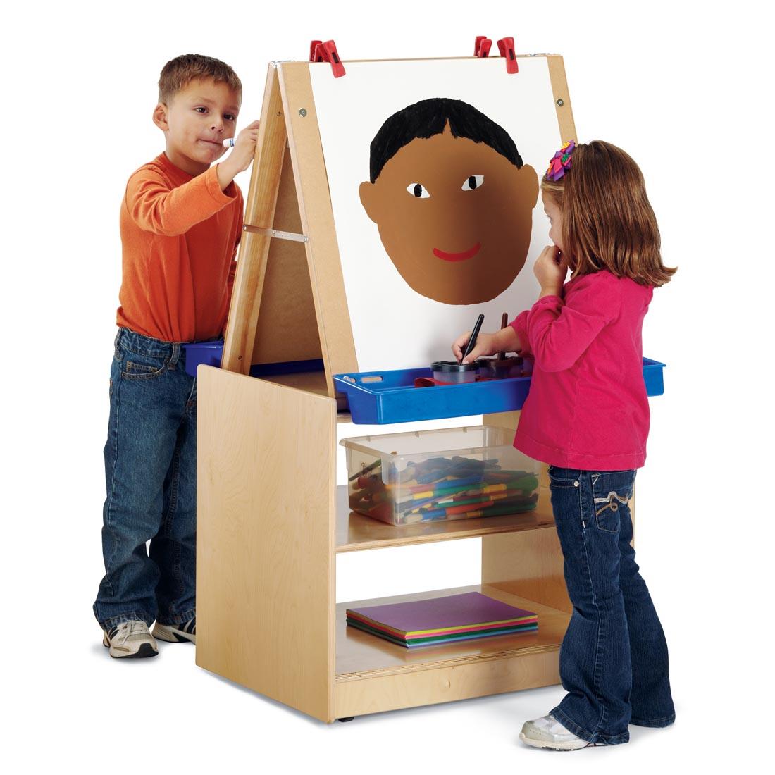 Two children creating art at the Two-Station Easel