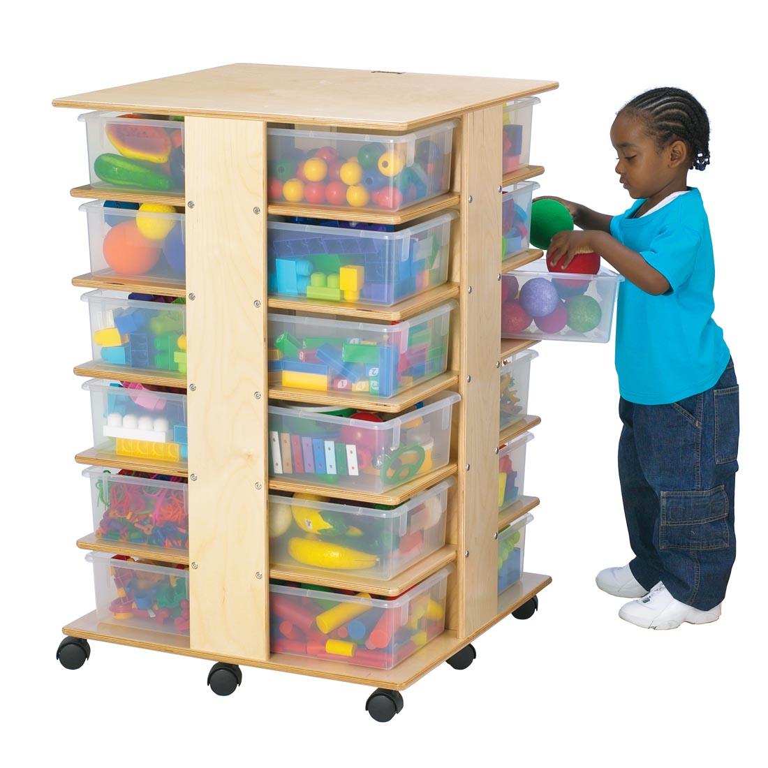 Child standing at Cubbie Tower With Clear Tubs shown with suggested storage contents