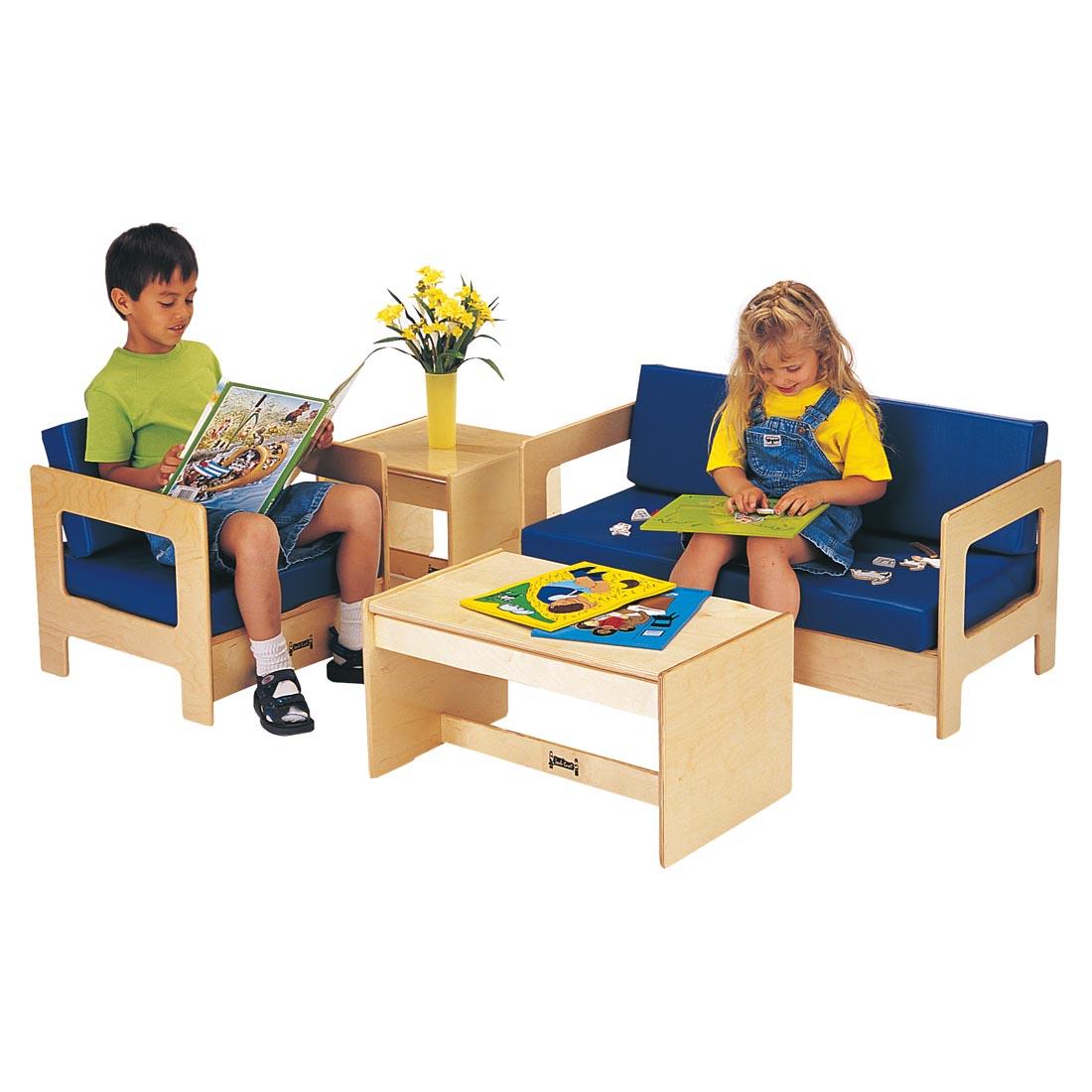 Two children sitting on the Living Room Set With Blue Cushions