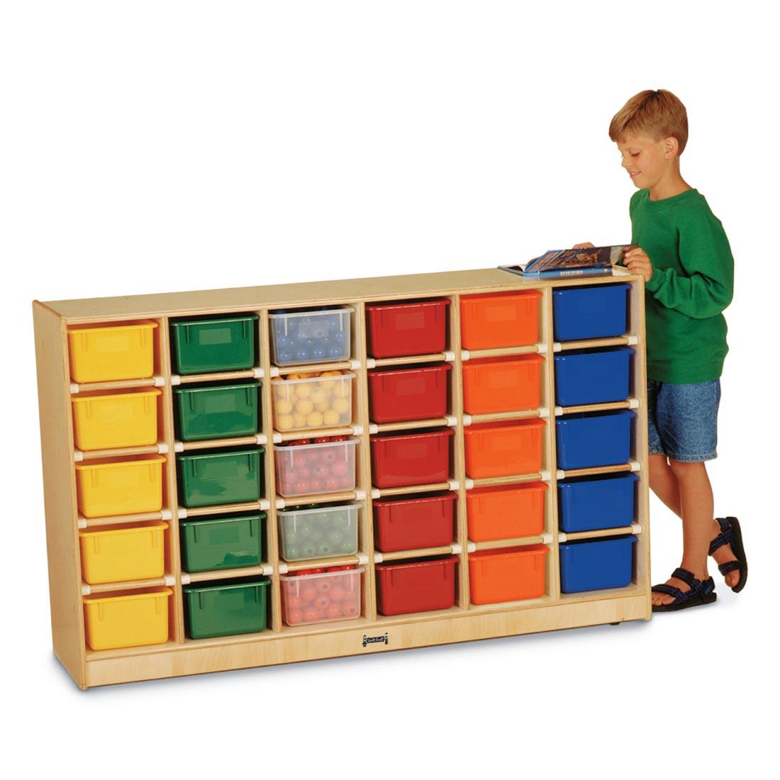 Child reading a book standing next to Mobile Cubbie With 30 Trays