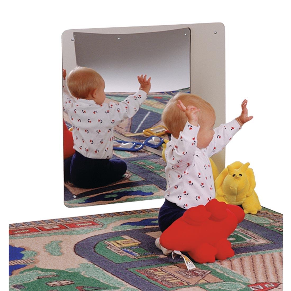 Child sitting next to the Acrylic Mirror