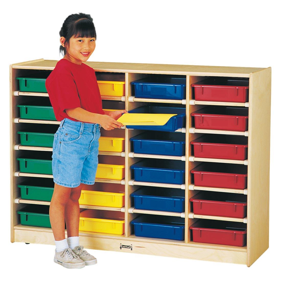 Child standing in front of the 24 Paper-Tray Mobile Storage With Colored Trays