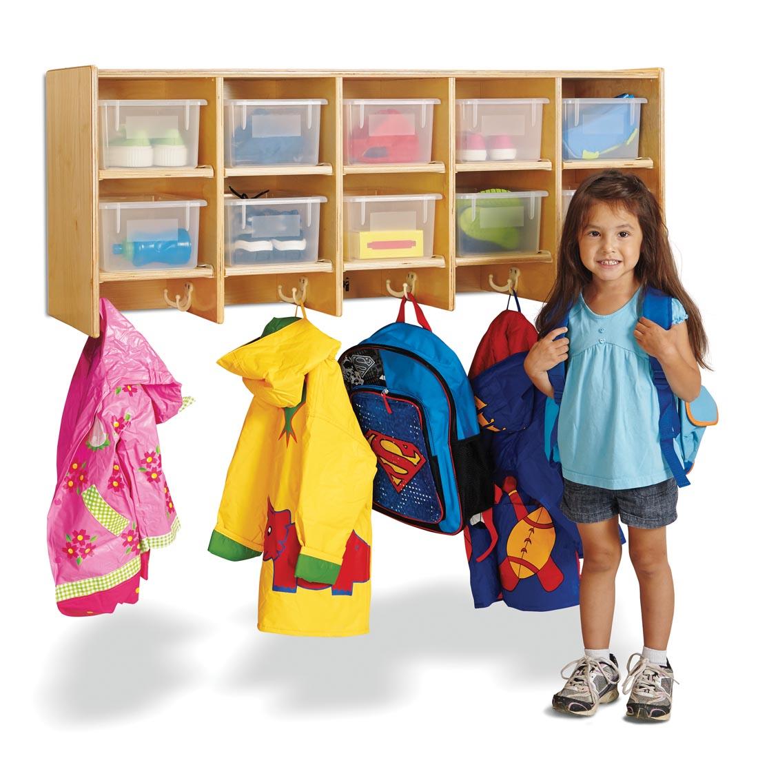 child standing in front of the Wall Mounted Coat Locker With Clear Trays