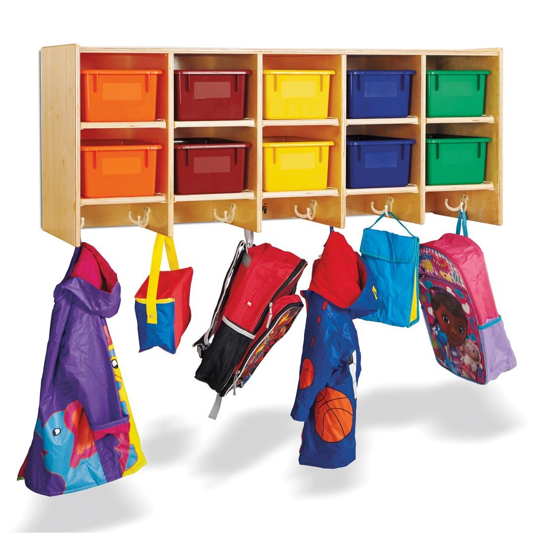 lunch boxes, backpacks and raincoats hanging from the Wall Mounted Coat Locker With Colored Trays
