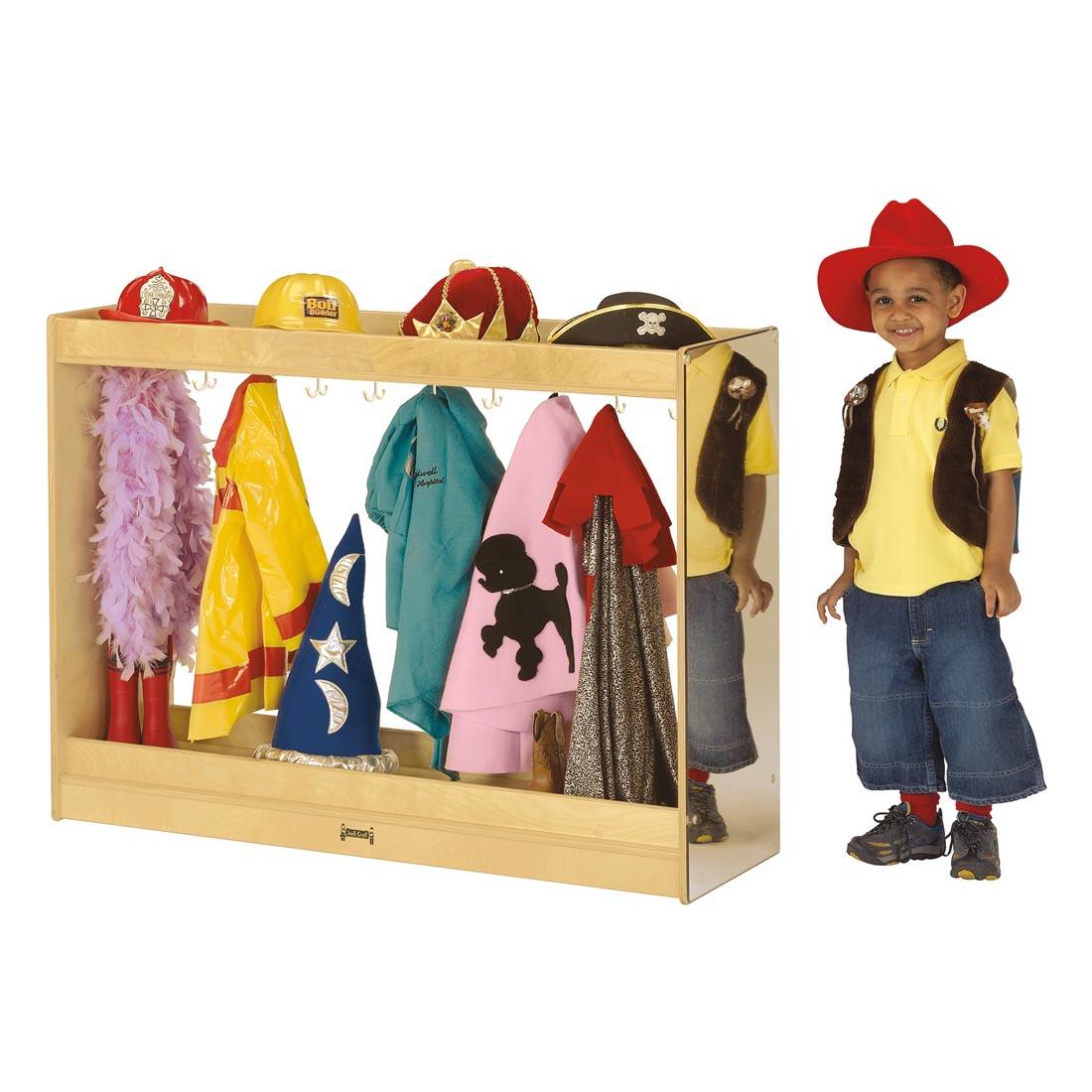 Child standing next to the Dress Up Island filled with costumes