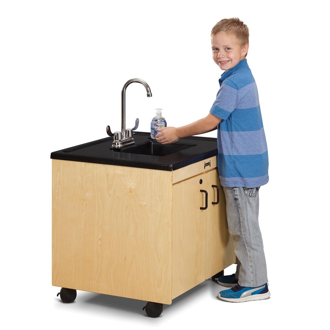 Child washing hands at the Clean Hands Helper Portable Plastic Sink