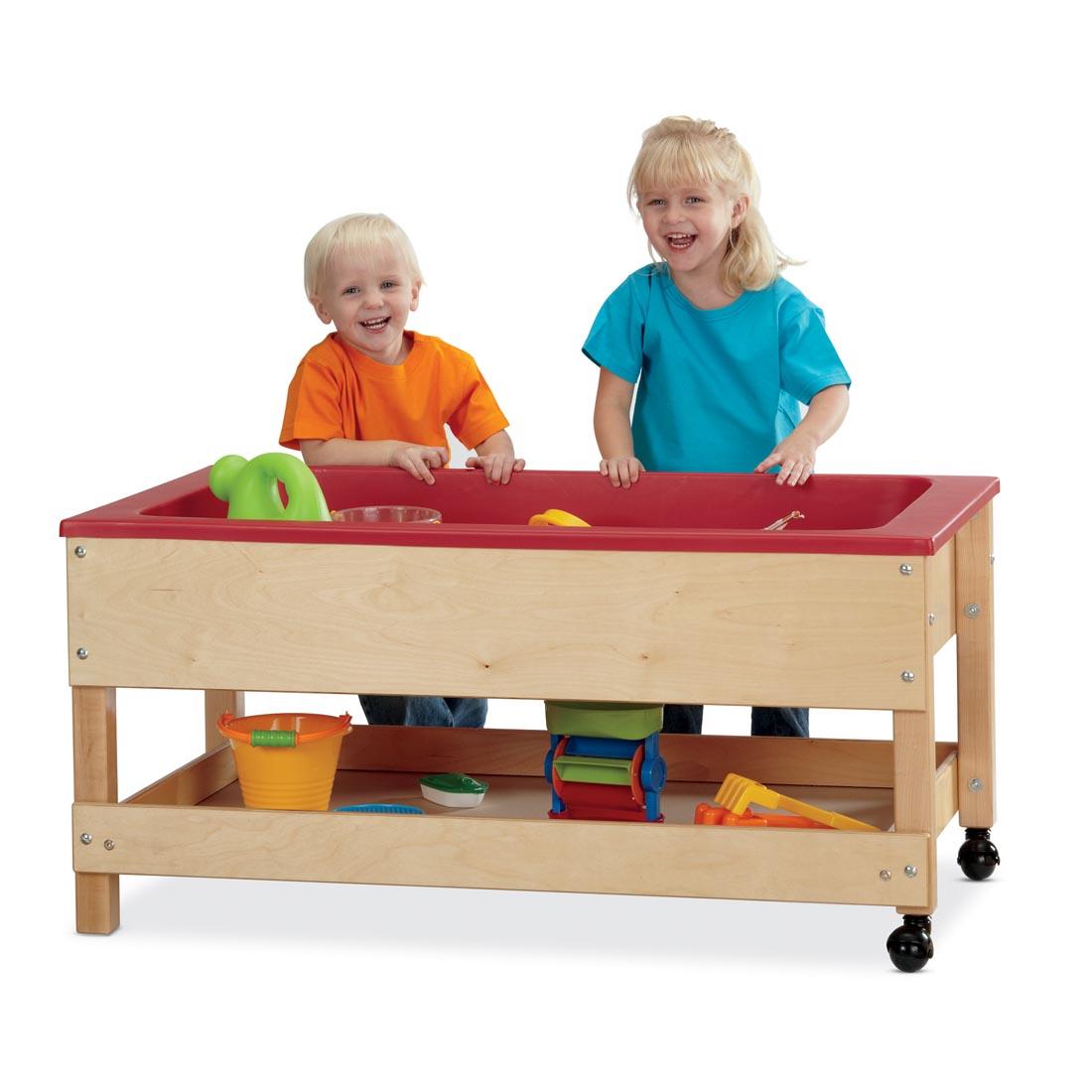 two children playing at the Sensory Table With Shelf