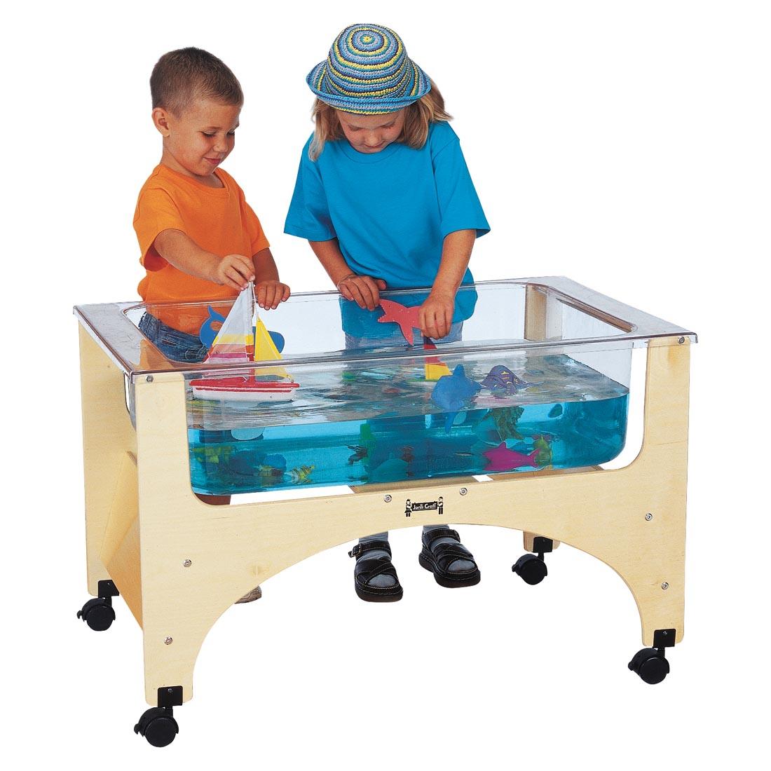 Two children playing at the See-Thru Sensory Table