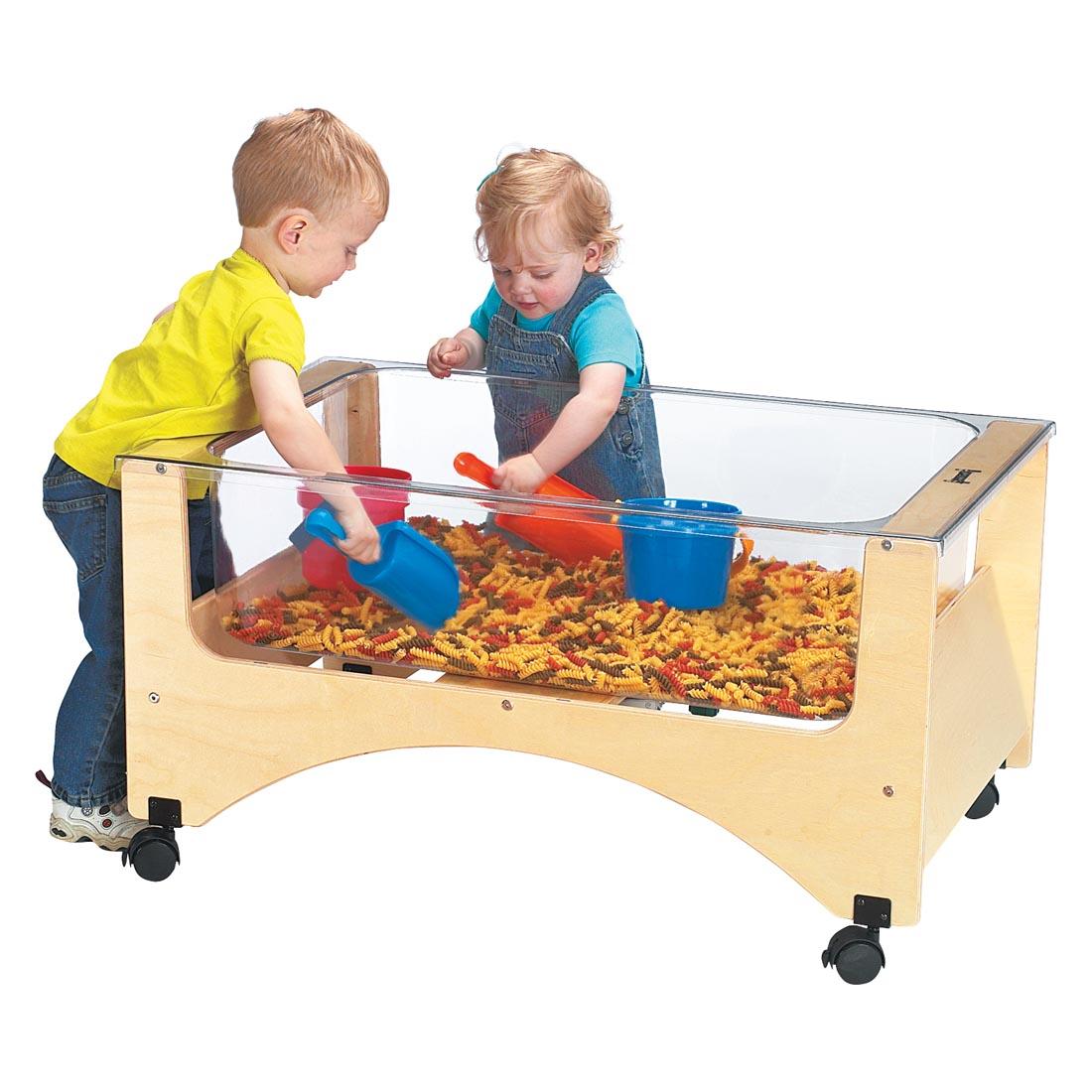 two children scooping pasta from the See-Thru Sensory Table