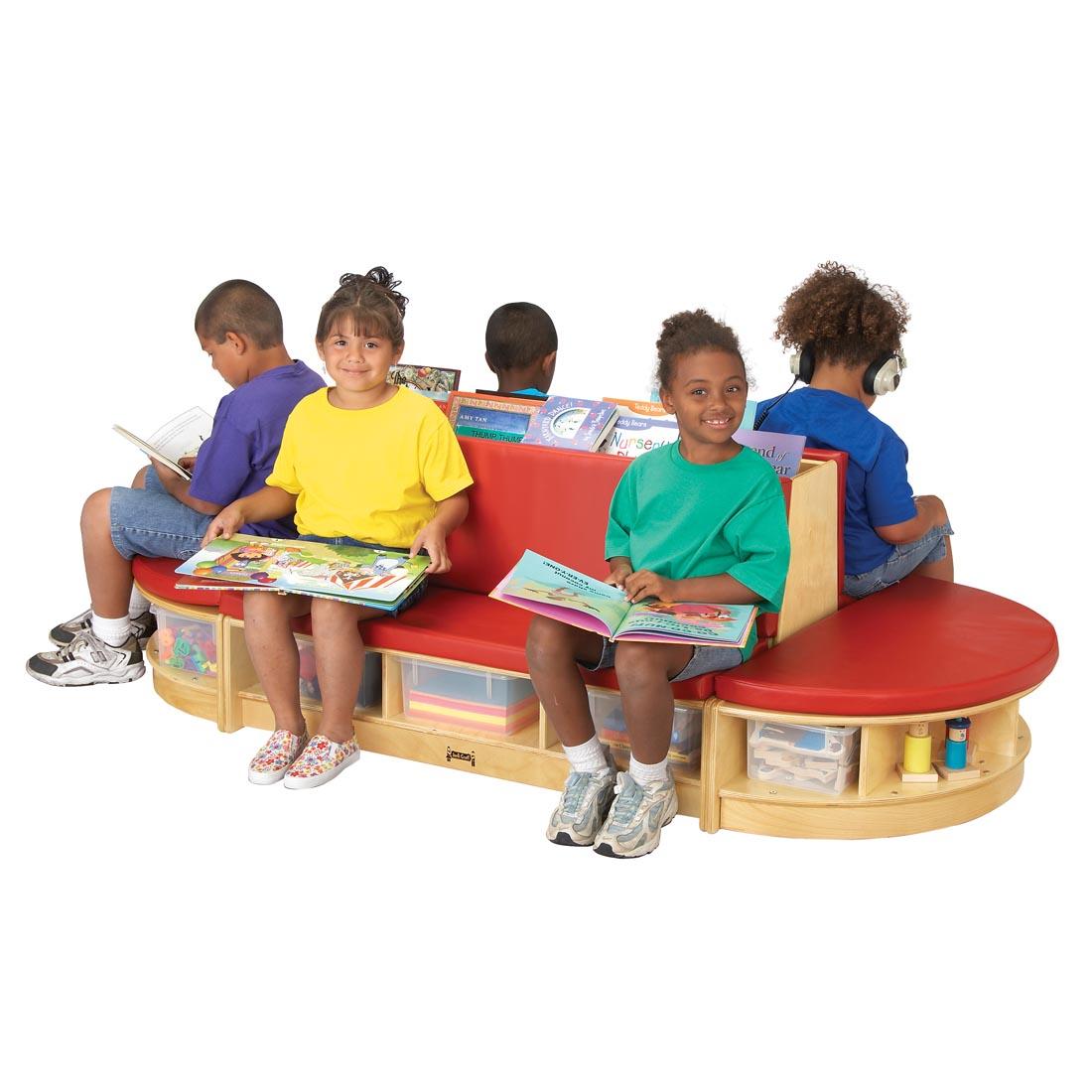 Children with books sitting on the Read-A-Round With Red Cushions