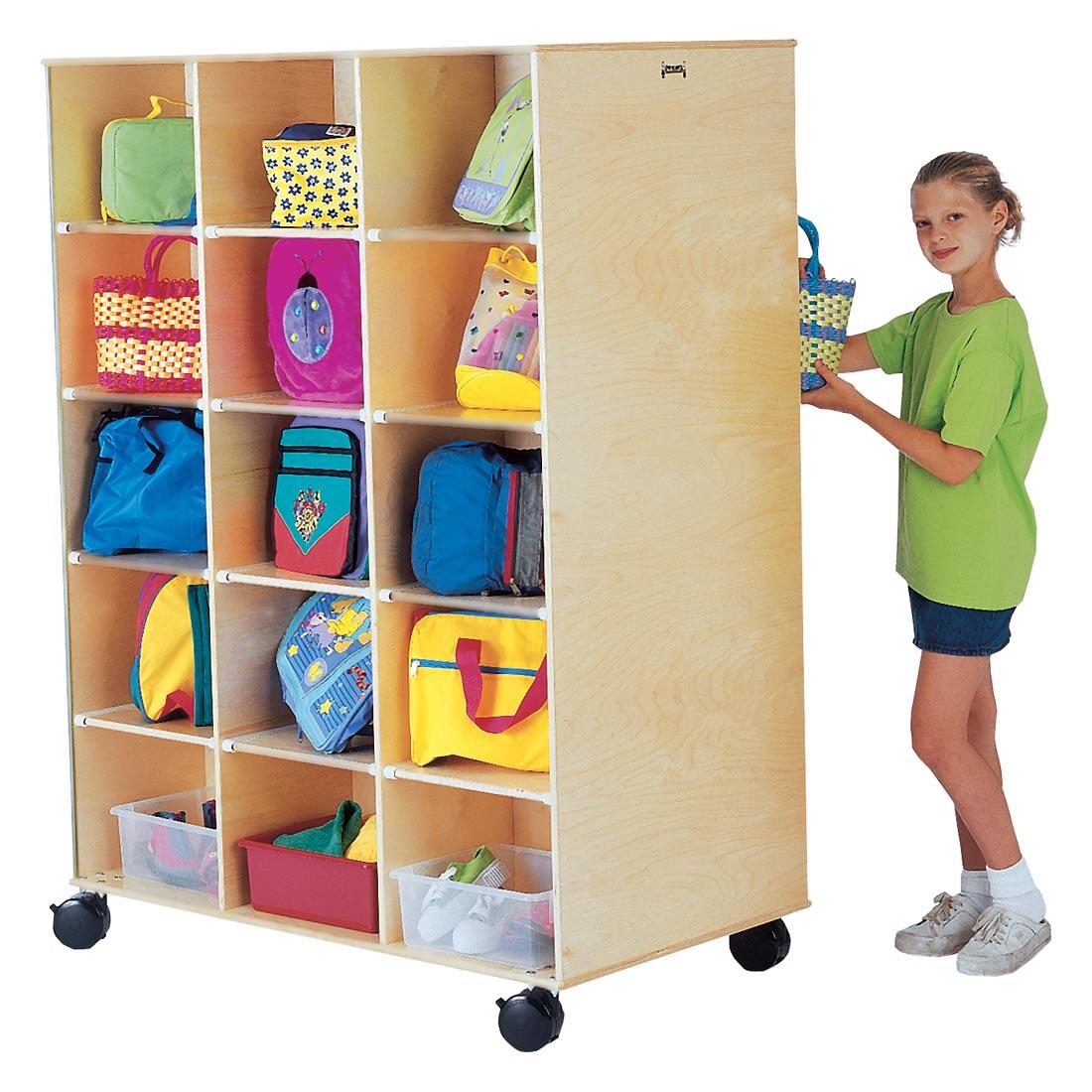 Child standing at the Big Twin Storage Center shown with suggested storage contents