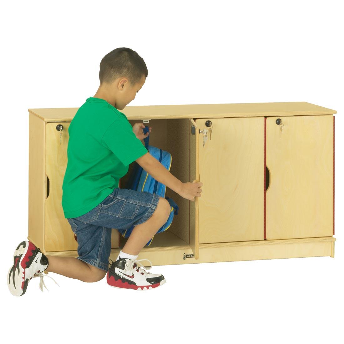 child putting backpack into the Single Stacking Locker