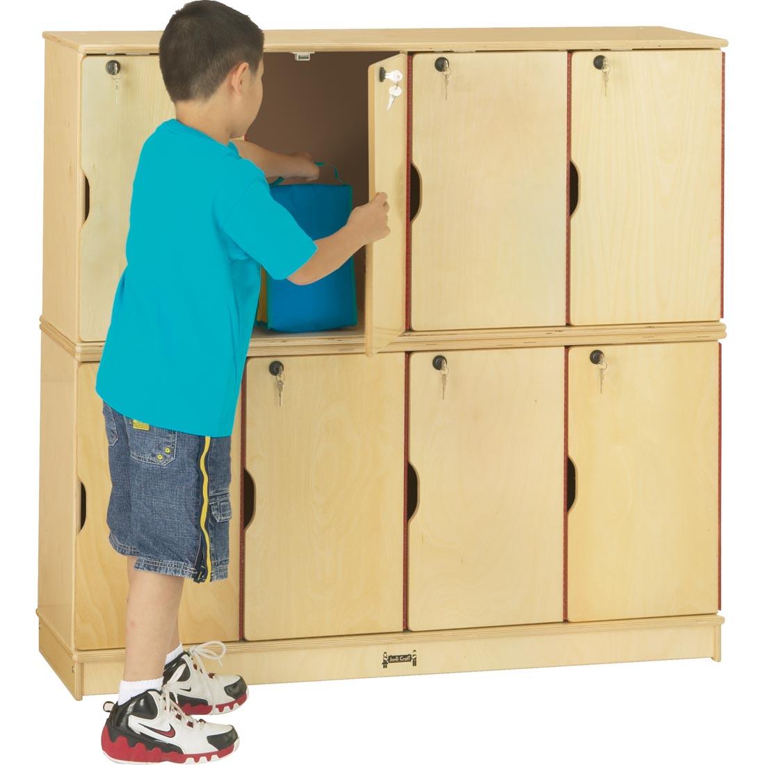 Child putting a lunch bag into the Double Stacking Locker
